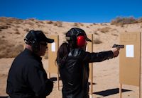 David Brown assisting a student on the firing range